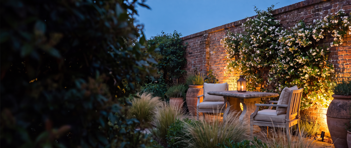 Walled garden courtyard glowing with warm light at dusk