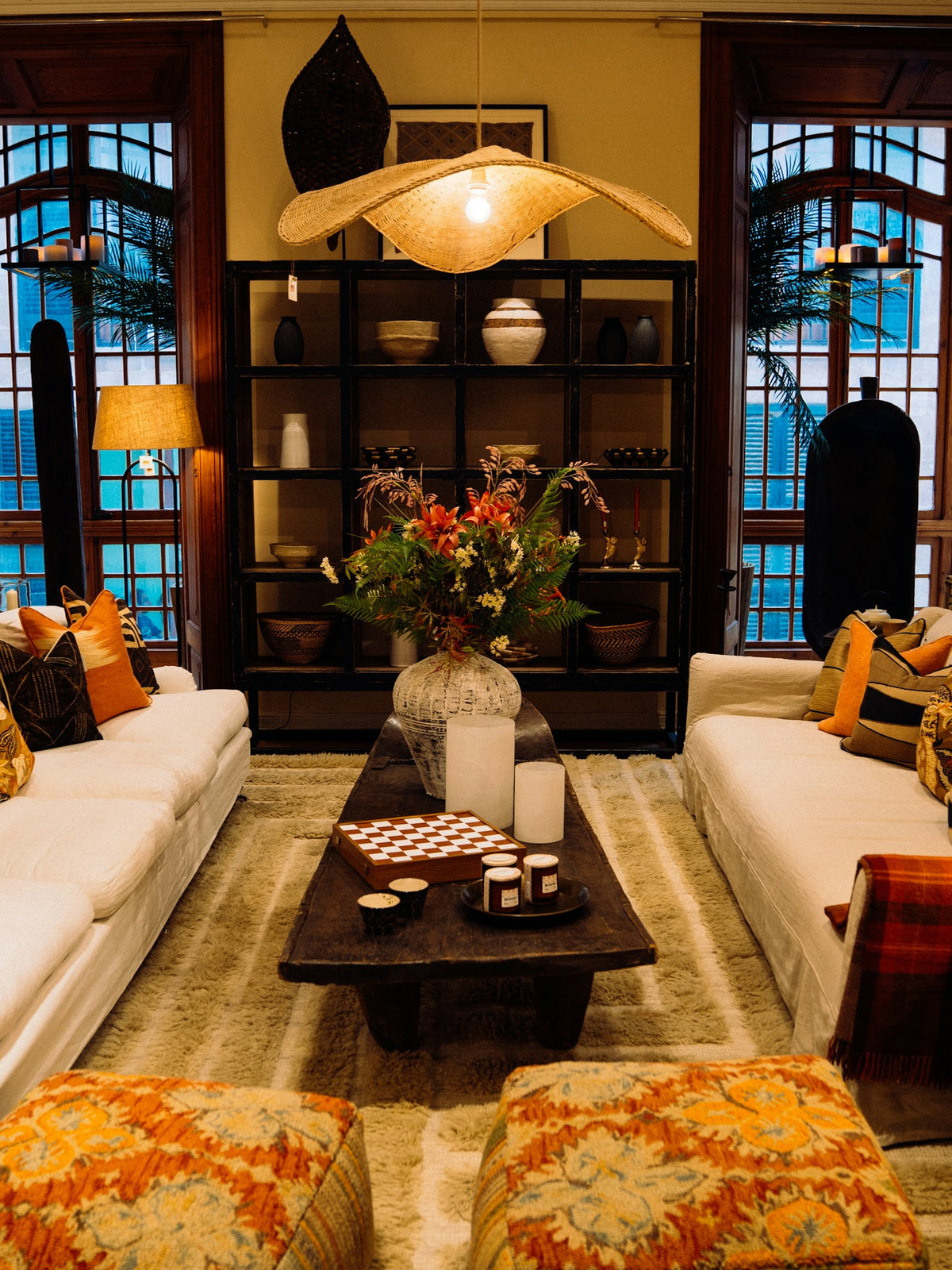 Warm living room glowing with table lamps and soft cushions