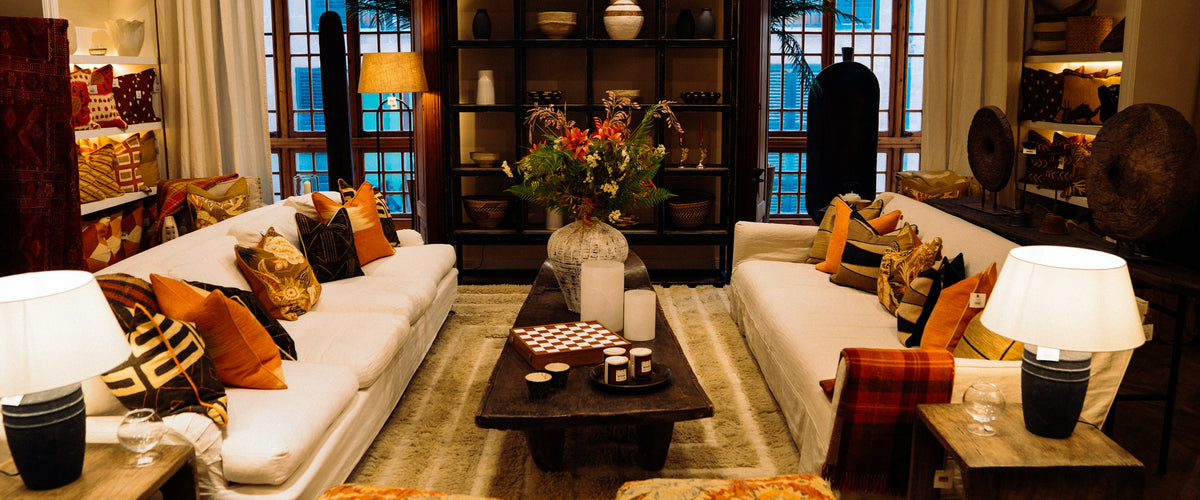 Warm living room glowing with table lamps and soft cushions